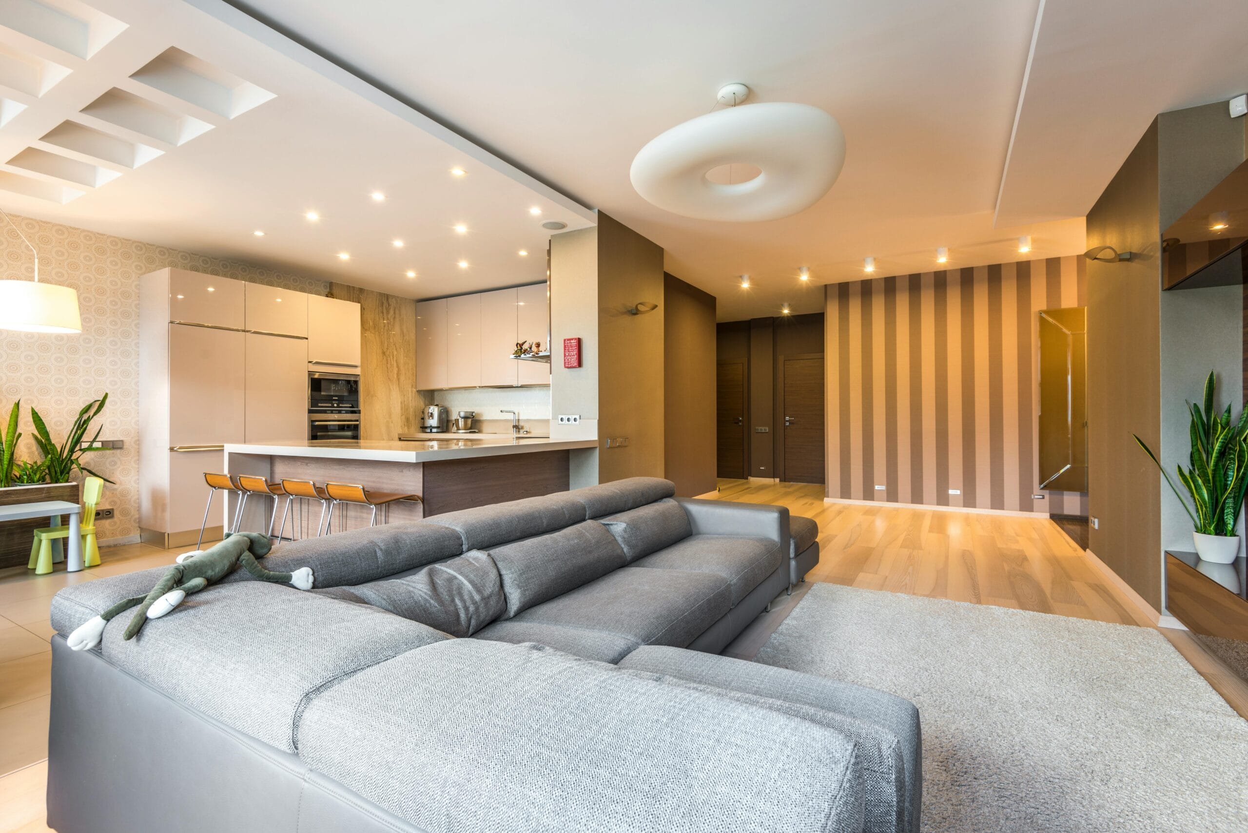 Spacious and elegantly designed open-concept living room with modern kitchen and dining area.